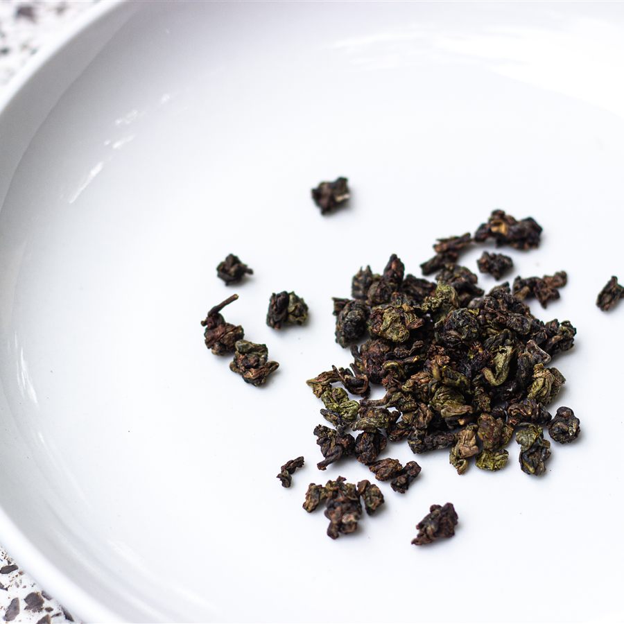 Oolong leaves resting in a white bowl
